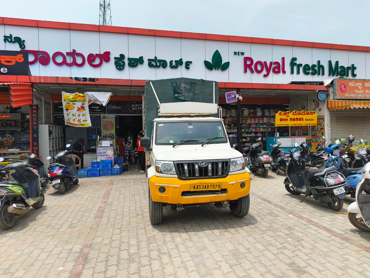New Royal Fresh Mart storefront with delivery truck